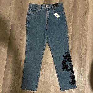 Express denim jeans with black embroidery on left leg. NWT